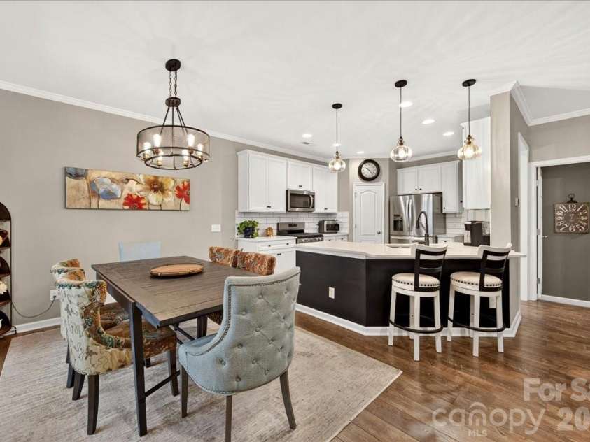 3093 Hartson Pointe Drive, Fort Mill, SC 29707.  MLS# CAR4402189, YatesRealty ID 37679. Open-concept dining and kitchen area featuring barstool seating.