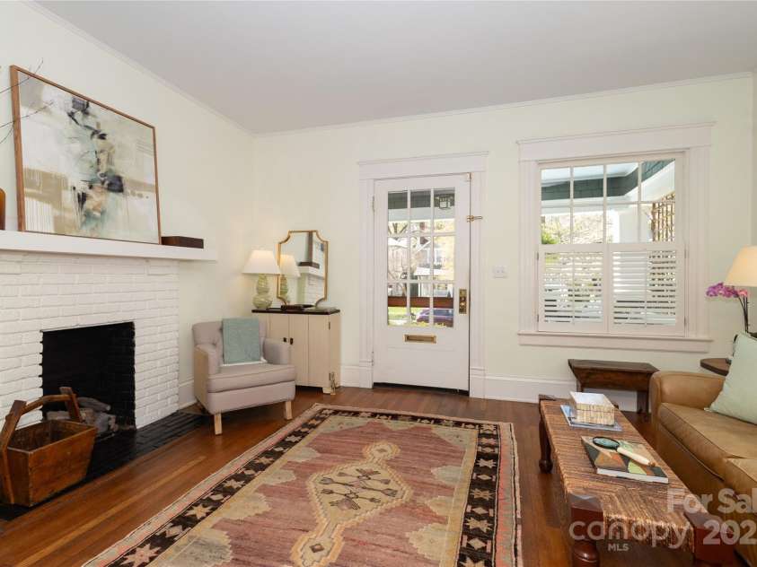 809 Worthington Avenue, Charlotte, NC 28203.  MLS# CAR4230687, YatesRealty ID 3769. Light filled living room with the classic Dilworth bungalow fireplace and ten foot ceilings