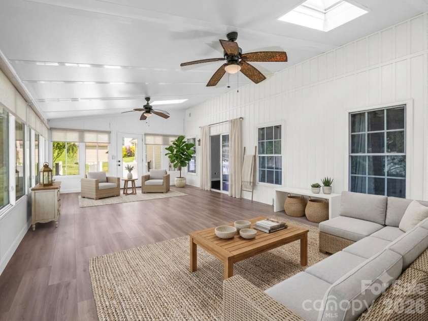355 Hidden Meadow Drive, Hendersonville, NC 28792.  MLS# CAR4403011, YatesRealty ID 37699. 29 x 15 Sunroom with new LVP + mini-split (virtually staged)