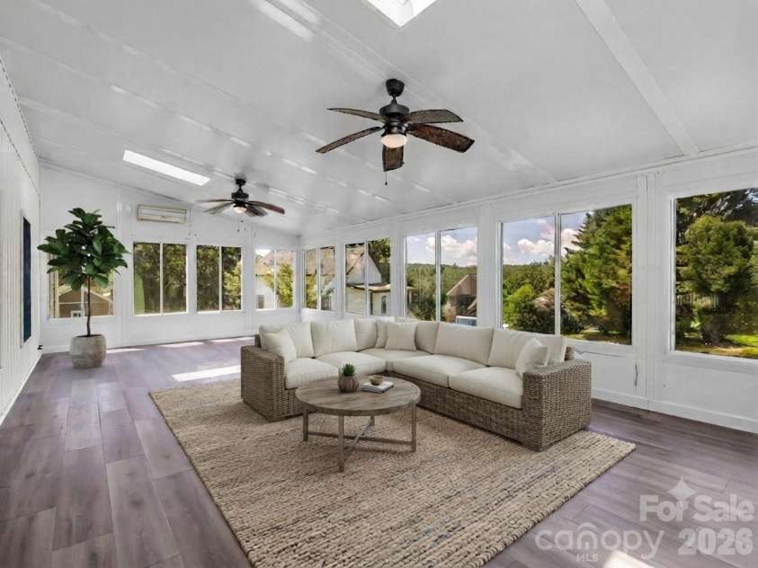 355 Hidden Meadow Drive, Hendersonville, NC 28792.  MLS# CAR4403011, YatesRealty ID 37699. 29 x 15 Sunroom with new LVP + mini-split. Virtually Staged