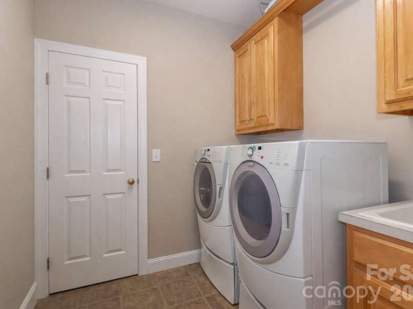 119 Shelter Cove Lane, Mooresville, NC 28117.  MLS# CAR4365805, YatesRealty ID 37707. Laundry room is accessible from one of the primary bedroom closets