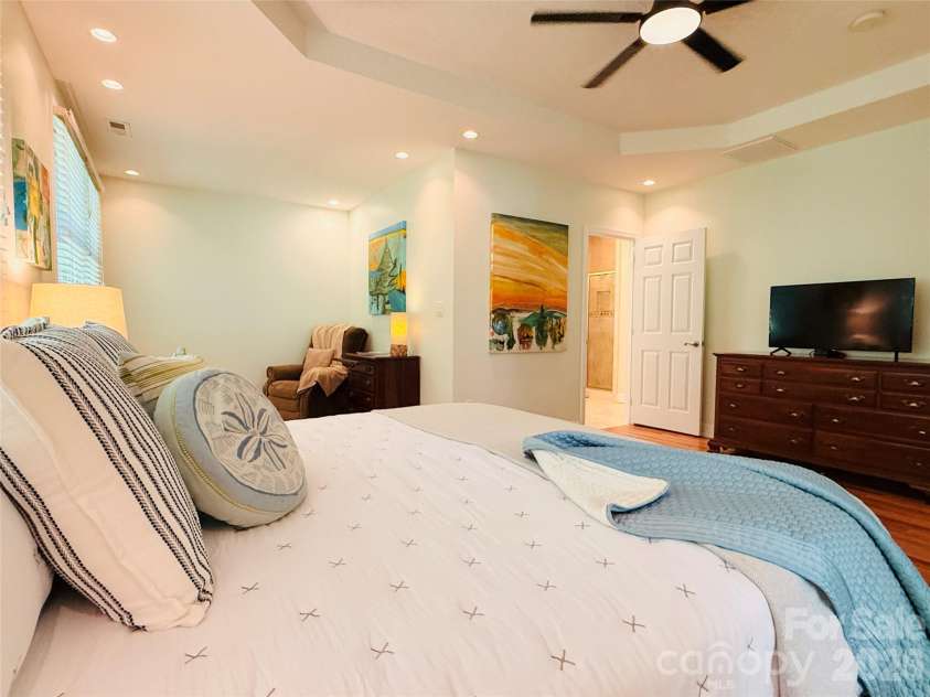2 Birkdale Drive, Weaverville, NC 28787.  MLS# CAR4399312, YatesRealty ID 37716. Spacious primary suite with sitting area and spacious bath with tiled shower, soaking tub, and private commode. Plus, a large walk-in closet