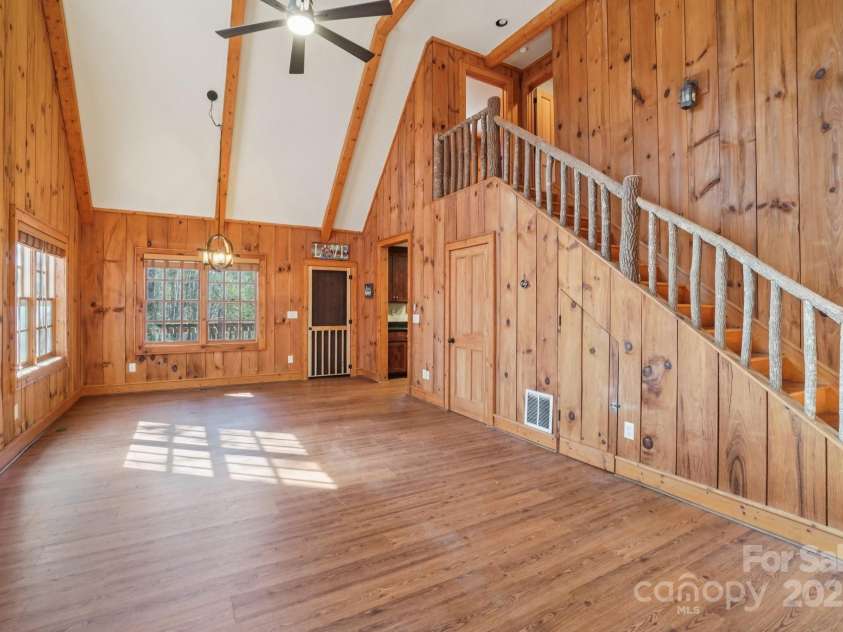 102 Knobster Way, Glenville, NC 28736.  MLS# CAR4325693, YatesRealty ID 3776. Enter at the bottom of a stairway.  To the left is an open, airy, family room