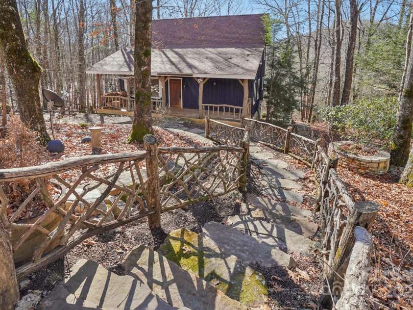 102 Knobster Way, Glenville, NC 28736.  MLS# CAR4325693, YatesRealty ID 3776. Stone steps lead to the door.