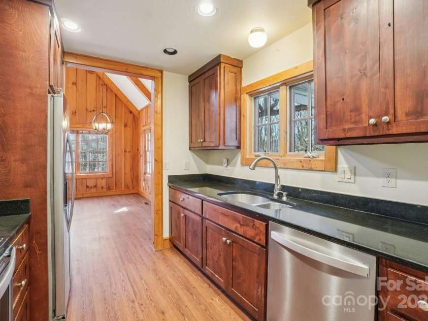 102 Knobster Way, Glenville, NC 28736.  MLS# CAR4325693, YatesRealty ID 3776. The kitchen window features the same mountain view as offered on the deck.