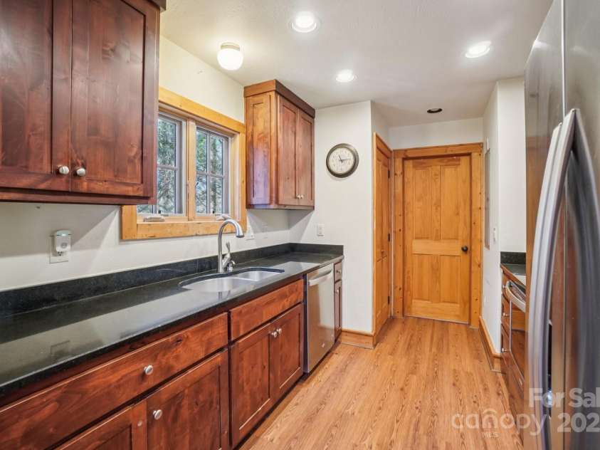 102 Knobster Way, Glenville, NC 28736.  MLS# CAR4325693, YatesRealty ID 3776. We enter the galley style kitchen.