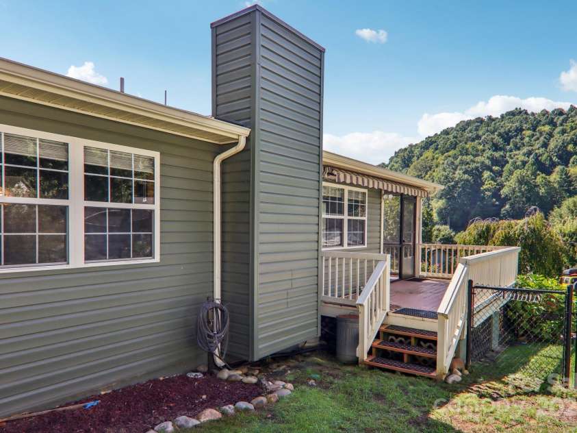 126 Pasco Loop, Waynesville, NC 28785.  MLS# CAR4301663, YatesRealty ID 378. Side of home from fenced in yard