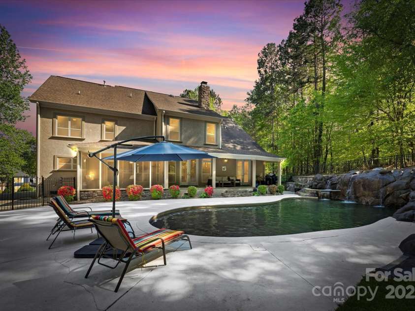 227 Wildwood Cove Drive, Mooresville, NC 28117.  MLS# CAR4214426, YatesRealty ID 3780. Enjoy the outdoors in your private backyard with pool, hot tub, sunning ledge, and waterfall.