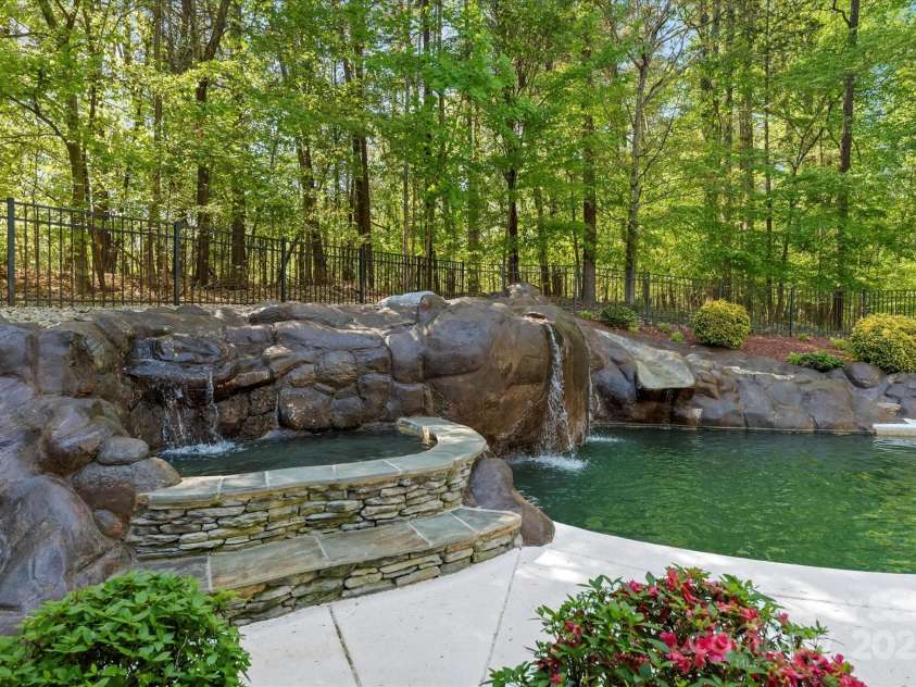227 Wildwood Cove Drive, Mooresville, NC 28117.  MLS# CAR4214426, YatesRealty ID 3780. Hot tub and waterfalls