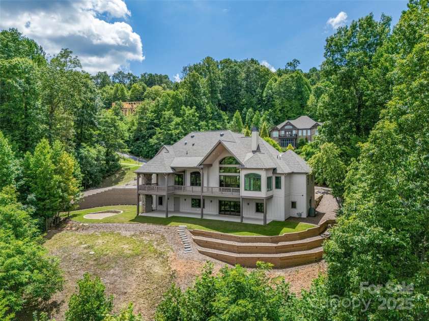 527 Falkirk Way, Zirconia, NC 28790.  MLS# CAR4231554, YatesRealty ID 3781. Back of the house showing tiered garden space