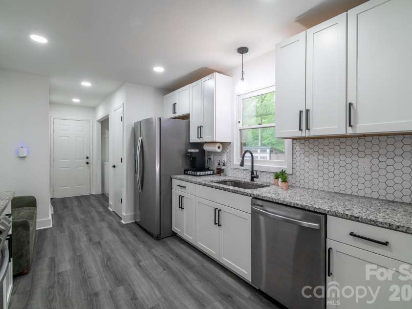 2406 Bearskin Lane, Monroe, NC 28110.  MLS# CAR4396948, YatesRealty ID 37817. Kitchen beside Laundry area