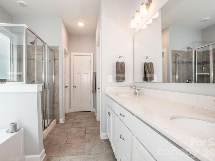 13331 Caite Ridge Road, Davidson, NC 28036.  MLS# CAR4402255, YatesRealty ID 37876. The primary bath includes upgraded pull out drawers in the vanity plus a linen closet