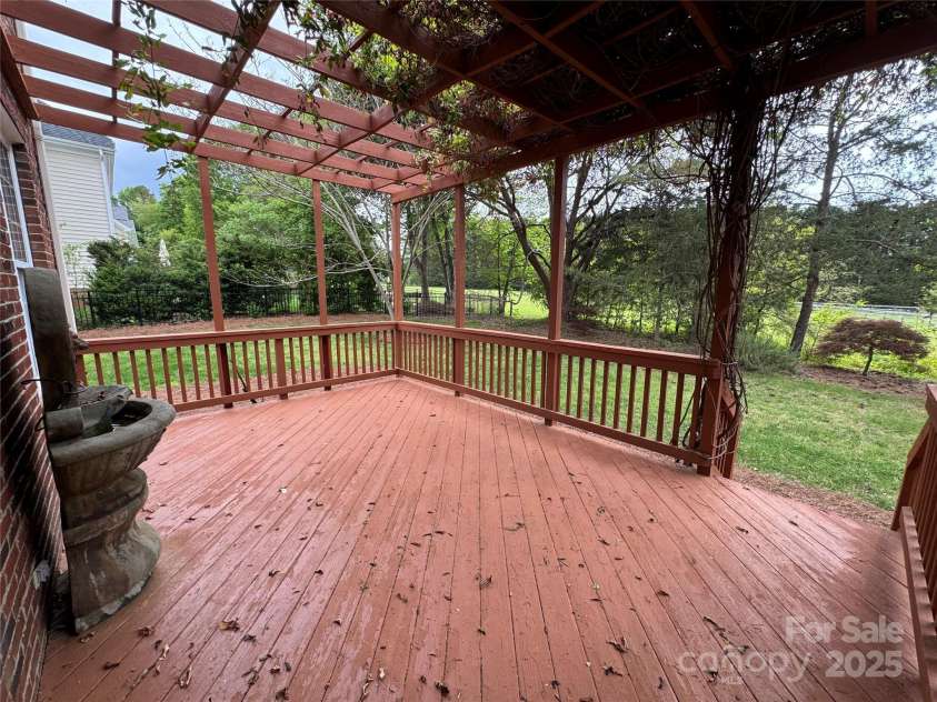 6316 Glengarrie Lane, Huntersville, NC 28078.  MLS# CAR4247118, YatesRealty ID 3788. Deck with pergola-beautiful blooms coming soon!