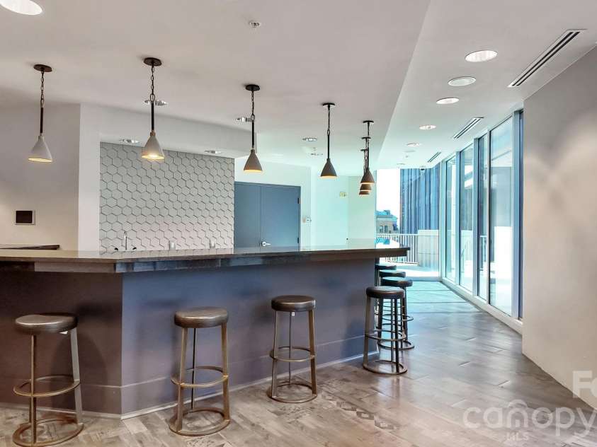 210 Church Street, Charlotte, NC 28202.  MLS# CAR4424880, YatesRealty ID 37967. Building amenity entertaining space