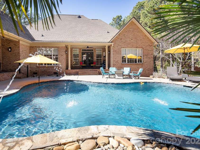 4706 Gold Finch Drive, Denver, NC 28037.  MLS# CAR4237582, YatesRealty ID 3797. Amazing Outdoor Entertainment with salt water pool, two covered porch areas, patio, outdoor kitchen and low maintenance backyard landscaping