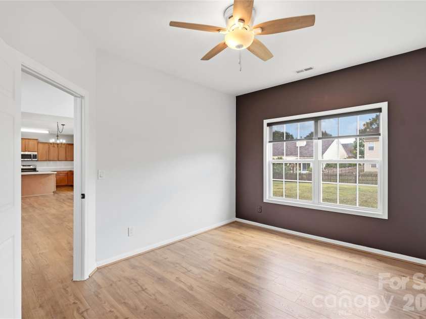 5803 Lindley Crescent Drive, Indian Trail, NC 28079.  MLS# CAR4402158, YatesRealty ID 37988. Private main-level office with new solid core door, ceiling fan, and designer accent wall