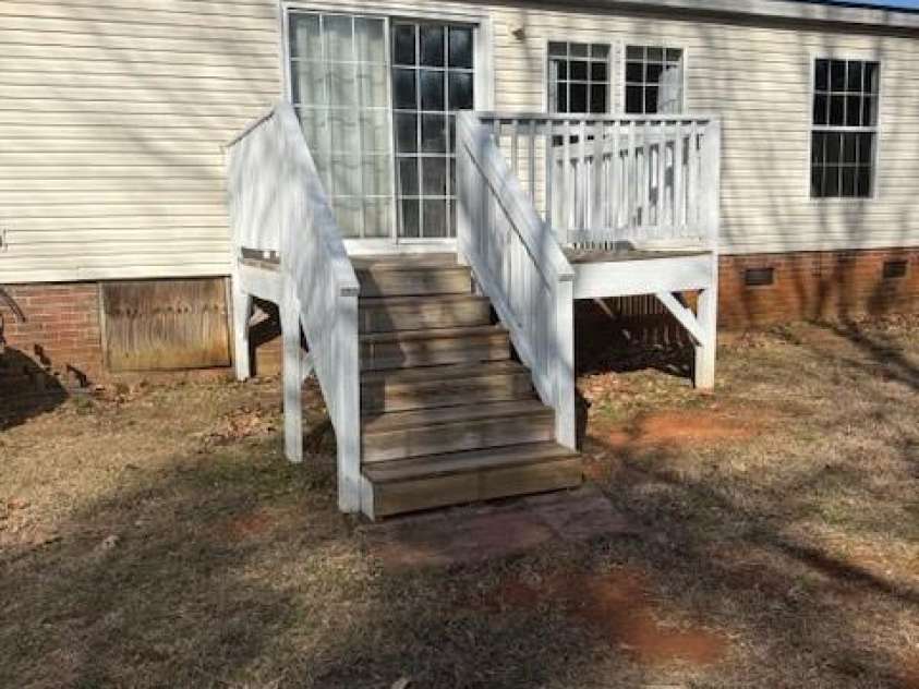 127 Knight N Gail Drive, Mooresville, NC 28115.  MLS# CAR4341014, YatesRealty ID 3799.  backyard deck w/ large backyard backed up to trees