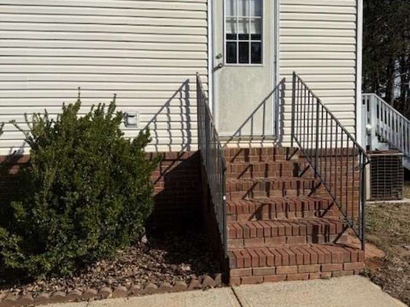 127 Knight N Gail Drive, Mooresville, NC 28115.  MLS# CAR4341014, YatesRealty ID 3799. Side Service Door w safety railing 