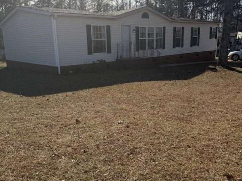 127 Knight N Gail Drive, Mooresville, NC 28115.  MLS# CAR4341014, YatesRealty ID 3799. Spacious Mobile Home -Front White vinyl-   Green Shutters on .47 acres
