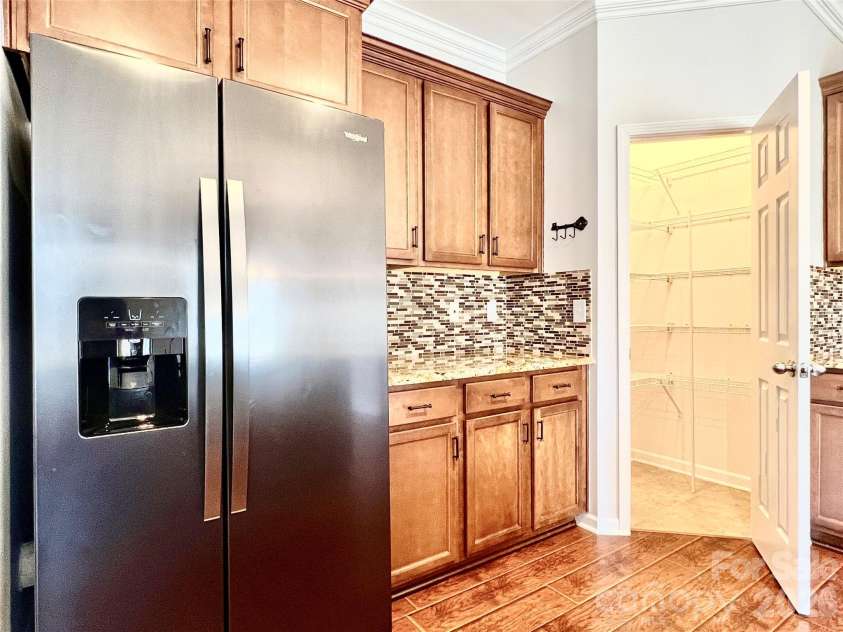 2021 Blue Stream Lane, Indian Trail, NC 28079.  MLS# CAR4379925, YatesRealty ID 38034. Pantry, Black Stainless Refrigerator