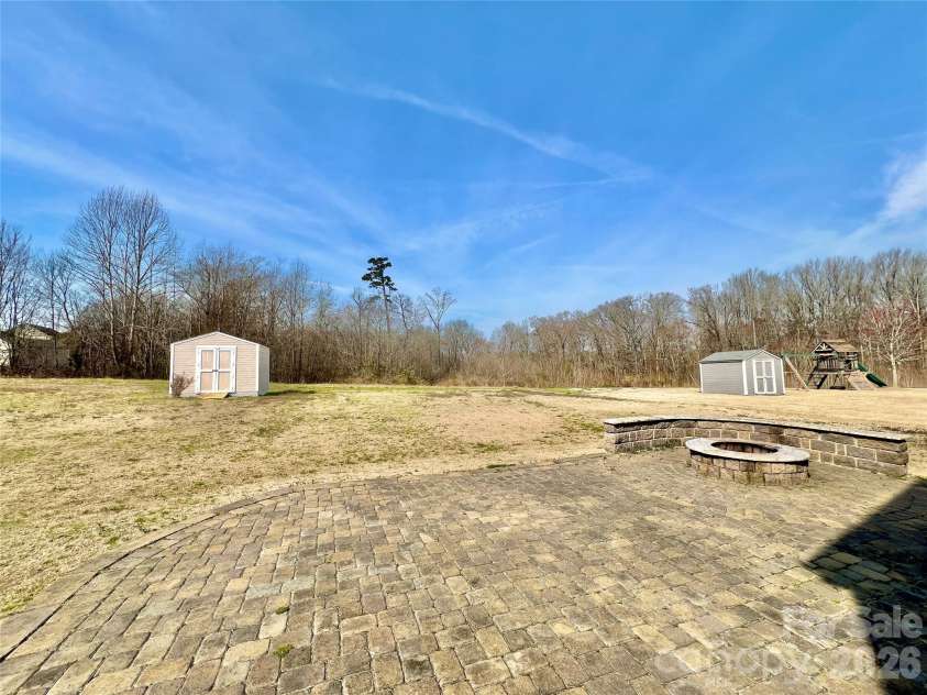 2021 Blue Stream Lane, Indian Trail, NC 28079.  MLS# CAR4379925, YatesRealty ID 38034. Trees, Common Area,Beautifully designed Pavers on oversized patio!