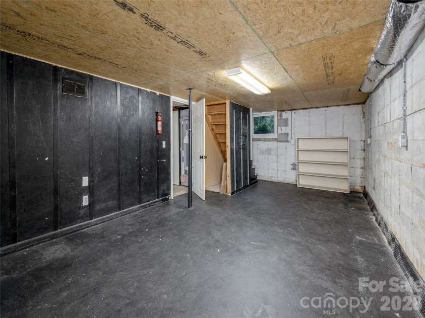 340 Mauney Cove, Waynesville, NC 28786.  MLS# CAR4401250, YatesRealty ID 38064. Basement storage space back section with additional storage space under the stairs