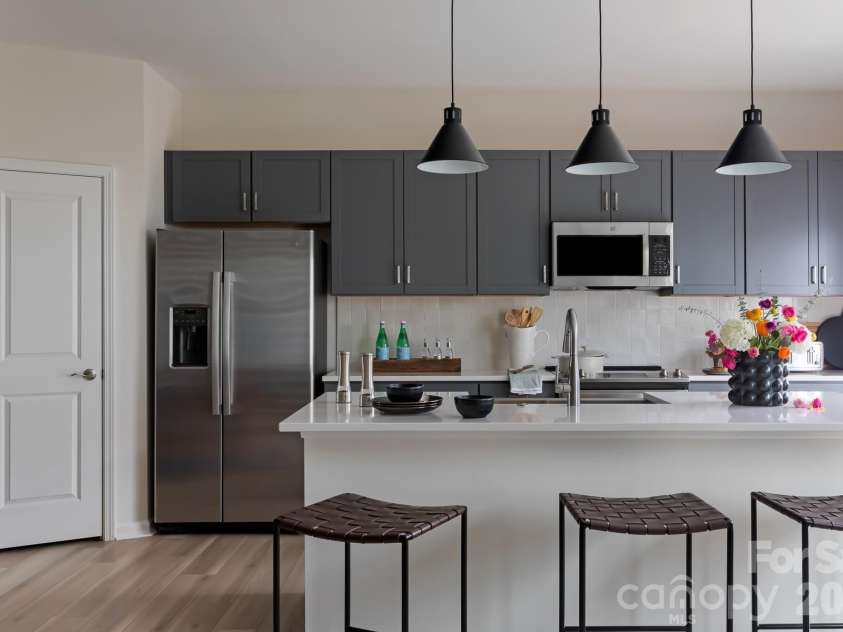 6029 Longar Lane, Charlotte, NC 28269.  MLS# CAR4400049, YatesRealty ID 38088. Rich grey cabinets and white quartz countertops