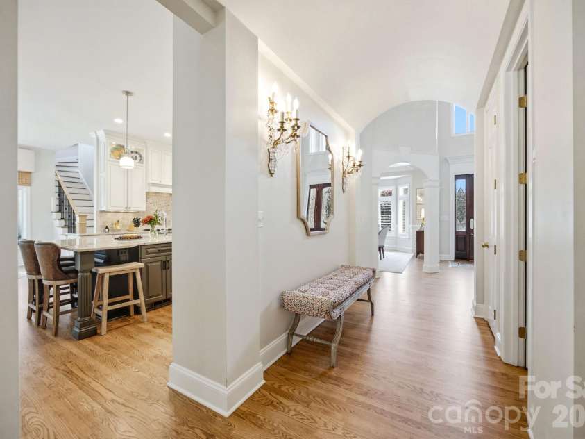 18416 Peninsula Club Drive, Cornelius, NC 28031.  MLS# CAR4432704, YatesRealty ID 38114. A graceful transitional hallway connecting the home's vibrant spaces.