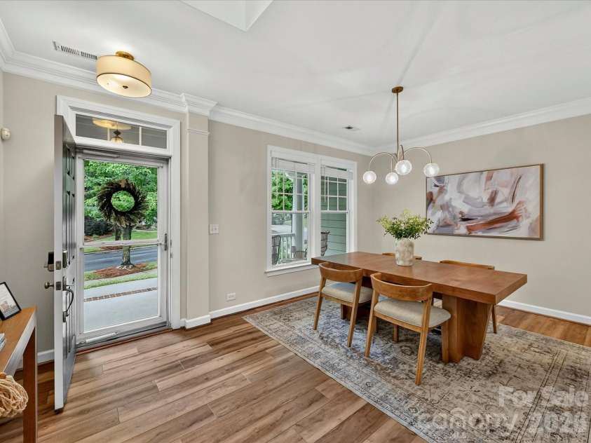 8707 Lake Pines Drive, Cornelius, NC 28031.  MLS# CAR4402781, YatesRealty ID 38115. Elegant dining room features abundant natural light, crown molding, and a spacious layout, creating the perfect setting for everyday meals and memorable gatherings.