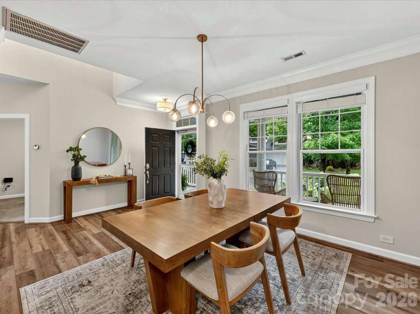 8707 Lake Pines Drive, Cornelius, NC 28031.  MLS# CAR4402781, YatesRealty ID 38115. Elegant dining room features abundant natural light, crown molding, and a spacious layout, creating the perfect setting for everyday meals and memorable gatherings.