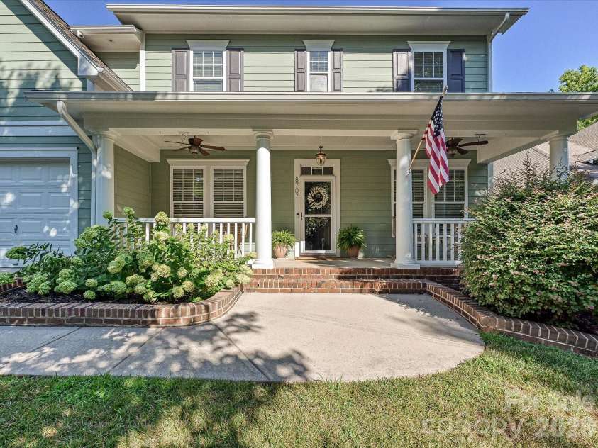 8707 Lake Pines Drive, Cornelius, NC 28031.  MLS# CAR4402781, YatesRealty ID 38115. Inviting covered front porch with stately columns creates a warm welcome and the perfect space to relax and enjoy the neighborhood.