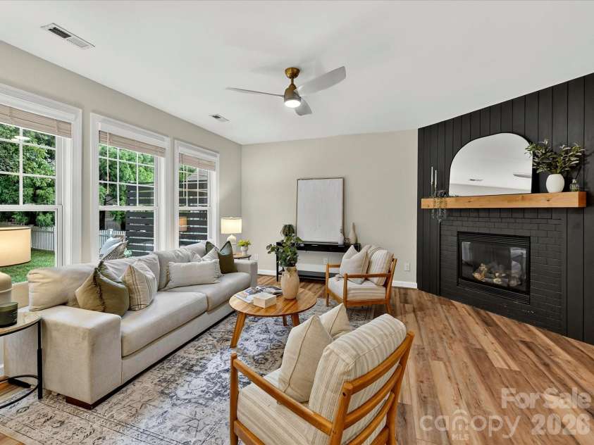 8707 Lake Pines Drive, Cornelius, NC 28031.  MLS# CAR4402781, YatesRealty ID 38115. Spacious Great Room showcases abundant natural light, a striking fireplace feature wall, and seamless open-concept flow to the kitchen, creating the perfect space for everyday living and entertaining.
