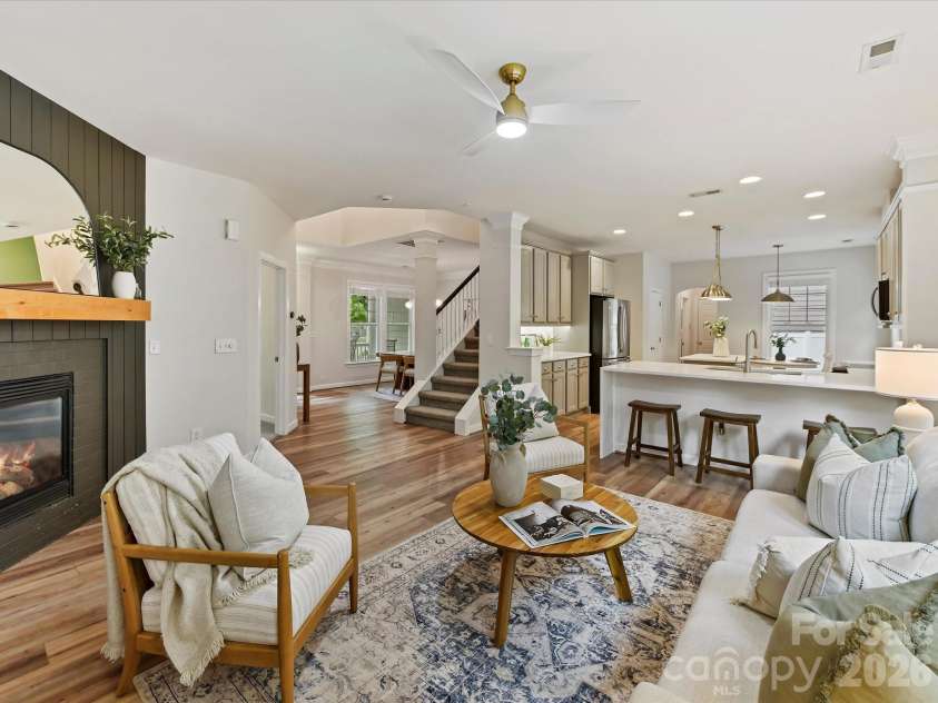 8707 Lake Pines Drive, Cornelius, NC 28031.  MLS# CAR4402781, YatesRealty ID 38115. Spacious open-concept Great Room features a cozy fireplace, abundant natural light, and seamless flow into the kitchen, creating an inviting space for everyday living and entertaining.