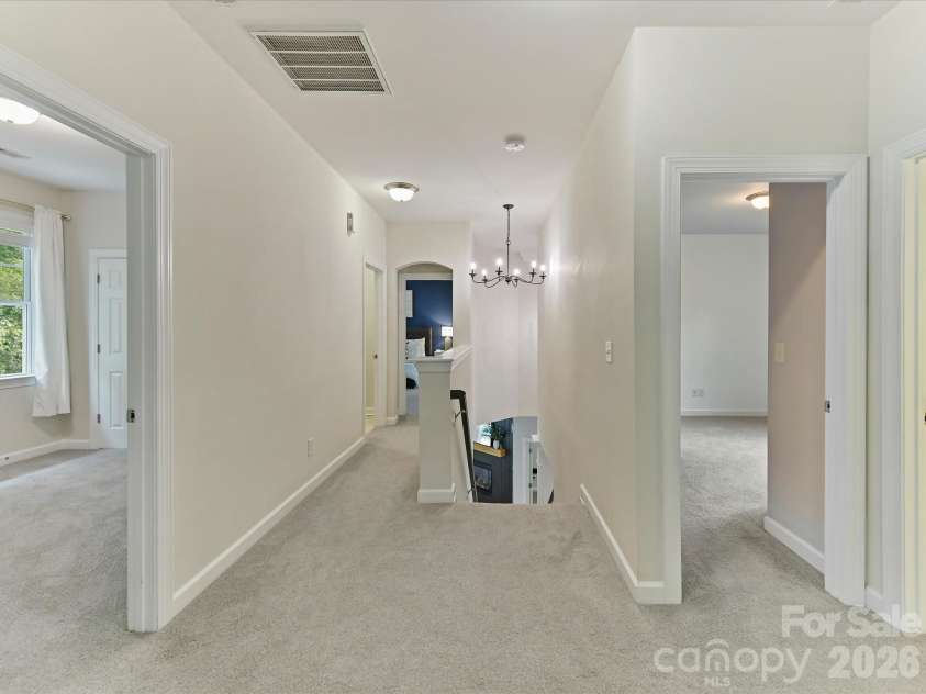 8707 Lake Pines Drive, Cornelius, NC 28031.  MLS# CAR4402781, YatesRealty ID 38115. Spacious upper-level landing provides convenient access to the bedrooms while creating an open and airy transition overlooking the main living area.