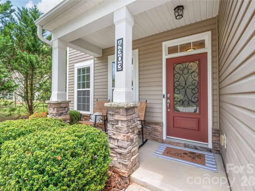 4303 Hampstead Heath Drive, Waxhaw, NC 28173.  MLS# CAR4402437, YatesRealty ID 38129. Stately stone-accented columns frame the inviting front porch, adding timeless craftsman charm and impressive curb appeal to your welcome home.