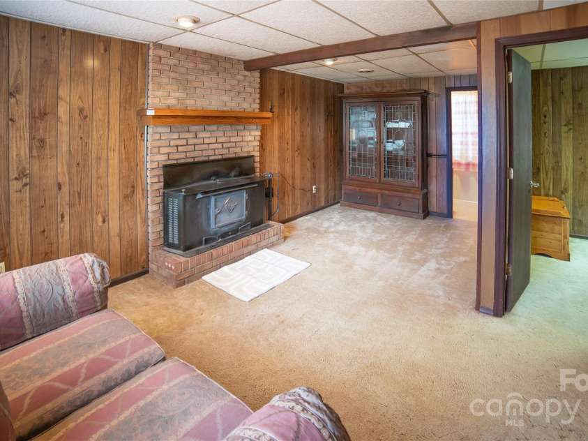 3154 Frank Whisnant Road, Morganton, NC 28655.  MLS# CAR4227309, YatesRealty ID 3813. Den w/ Wood Stove