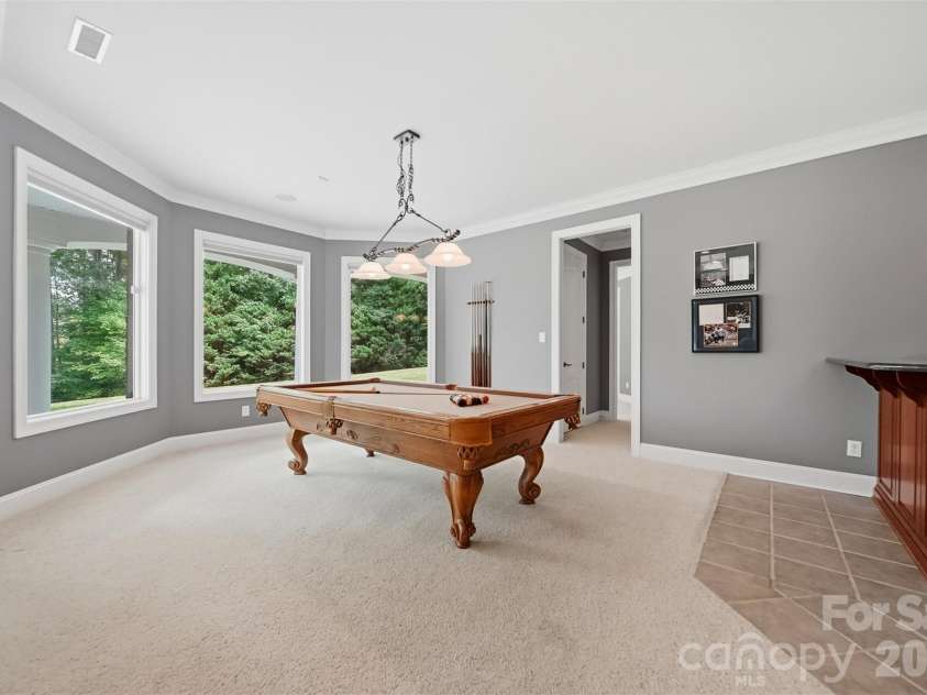 3745 Pinecrest Drive, Hickory, NC 28601.  MLS# CAR4403164, YatesRealty ID 38139. Basement Pool table area overlooking back yard and Golf Course.