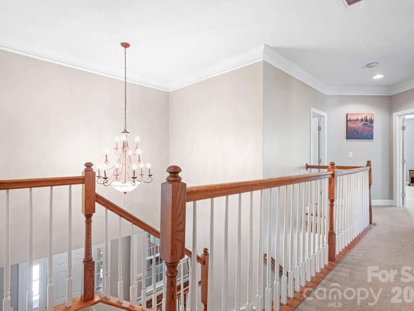 157 Eclipse Way, Mooresville, NC 28117.  MLS# CAR4405597, YatesRealty ID 38166. A dual staircase leads to the second level.