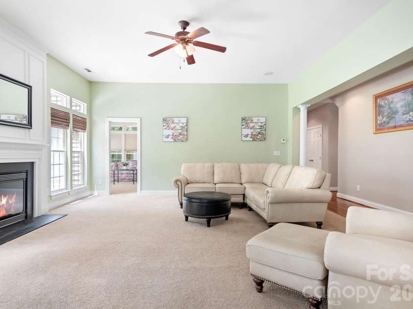157 Eclipse Way, Mooresville, NC 28117.  MLS# CAR4405597, YatesRealty ID 38166. A gas fireplace is flanked by double windows.
