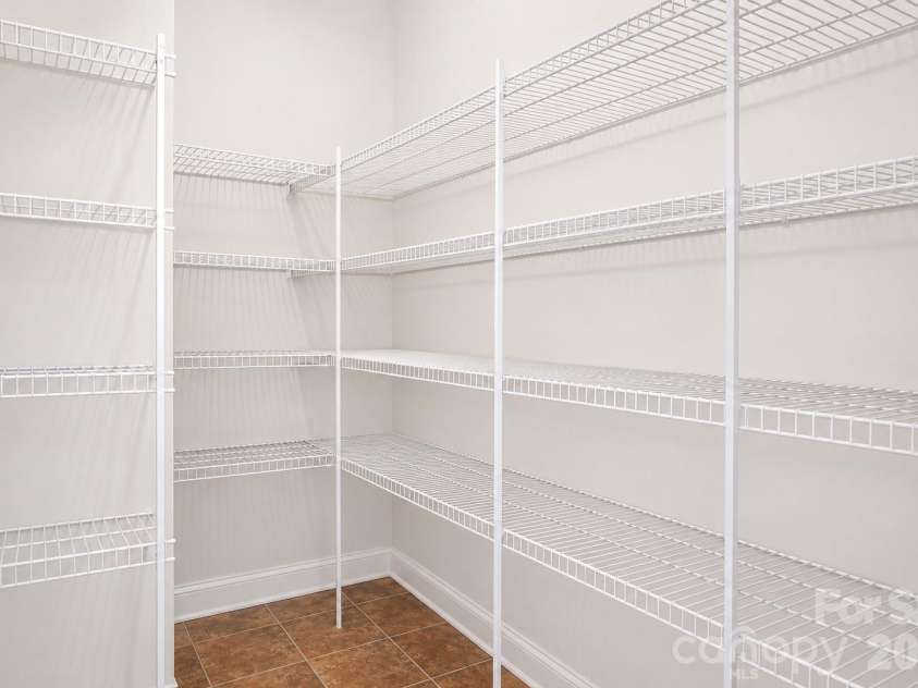 157 Eclipse Way, Mooresville, NC 28117.  MLS# CAR4405597, YatesRealty ID 38166. A walk in pantry grounds the kitchen with easy, abundant storage.