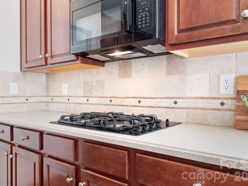 157 Eclipse Way, Mooresville, NC 28117.  MLS# CAR4405597, YatesRealty ID 38166. The gas cooktop with vented microwave.
