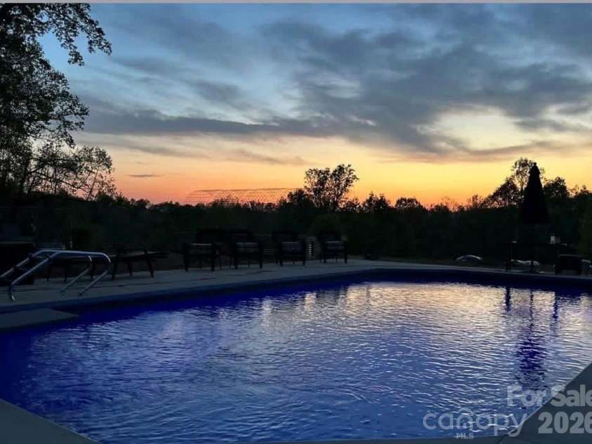 3430 Tranquil Hills Drive, Lenoir, NC 28645.  MLS# CAR4402608, YatesRealty ID 38174. Night Swimming with a View