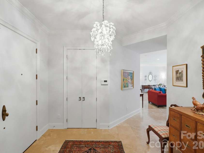 229 Church Street, Charlotte, NC 28202.  MLS# CAR4381312, YatesRealty ID 3818. Elegant entry foyer with high ceilings, designer lighting, and gallery style walls that create a sophisticated first impression.