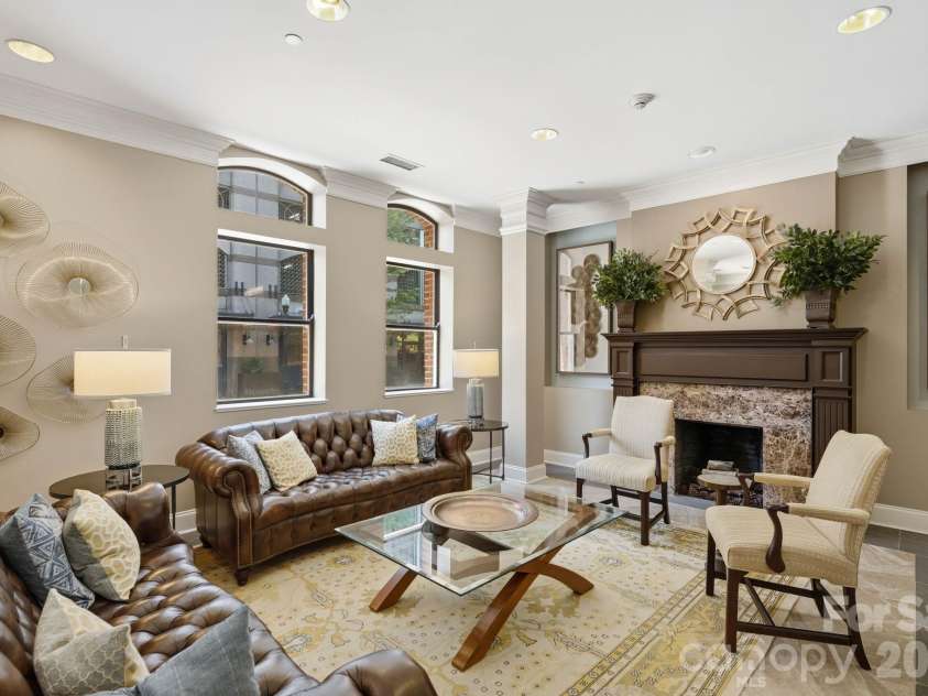 229 Church Street, Charlotte, NC 28202.  MLS# CAR4381312, YatesRealty ID 3818. Elegant resident lobby with sophisticated seating areas, fireplace, and timeless design details that create a warm and welcoming first impression.