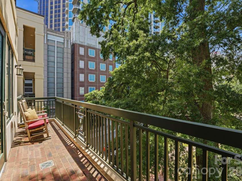 229 Church Street, Charlotte, NC 28202.  MLS# CAR4381312, YatesRealty ID 3818. Expansive covered terrace surrounded by mature trees offering a rare sense of privacy and tranquility in the heart of Uptown Charlotte. Perfect for morning coffee or evening entertaining.