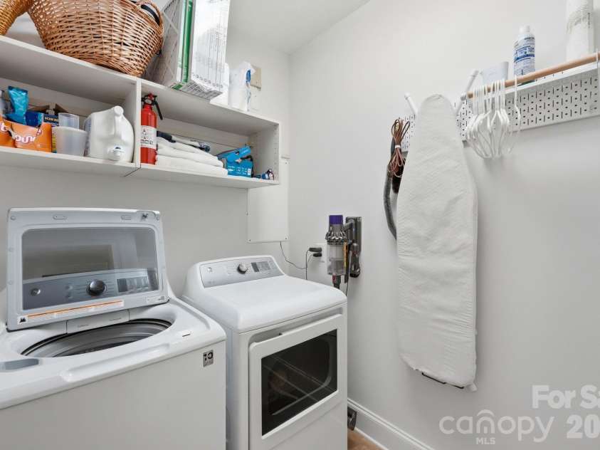 229 Church Street, Charlotte, NC 28202.  MLS# CAR4381312, YatesRealty ID 3818. Functional laundry room with built in shelving, additional storage space, and thoughtful organization for convenient everyday living.