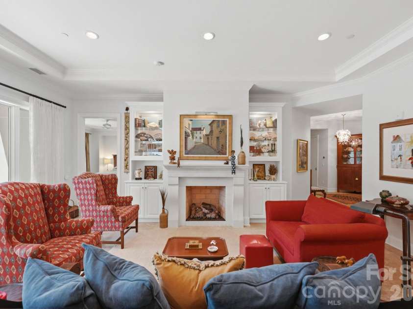 229 Church Street, Charlotte, NC 28202.  MLS# CAR4381312, YatesRealty ID 3818. Sophisticated living room featuring custom built ins, a statement fireplace, soaring ceilings, and elegant gathering spaces designed for both entertaining and everyday comfort.
