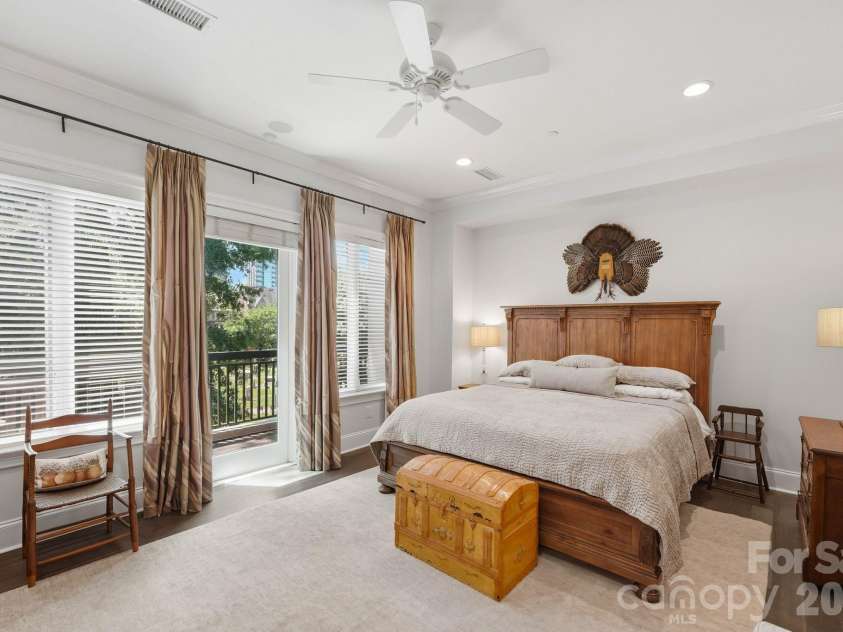 229 Church Street, Charlotte, NC 28202.  MLS# CAR4381312, YatesRealty ID 3818. Spacious primary suite with private balcony access, oversized windows, hardwood flooring, and a serene retreat like atmosphere in the heart of Uptown Charlotte.