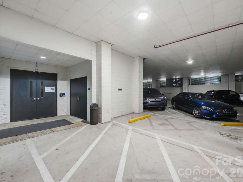 229 Church Street, Charlotte, NC 28202.  MLS# CAR4381312, YatesRealty ID 3818. Two conveniently located parking spaces directly across from the secured garage entry, providing effortless access into the building and residence.