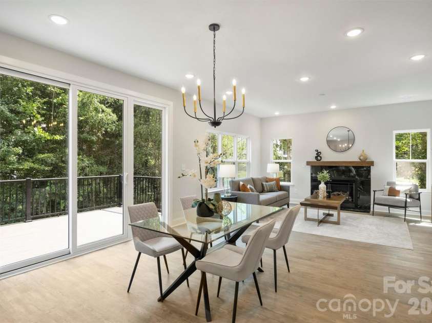 126 Meadow Glen Drive, Troutman, NC 28166.  MLS# CAR4340501, YatesRealty ID 3819. Dining area connecting the kitchen and living room, with glass sliding doors leading to the rear deck overlooking the backyard.